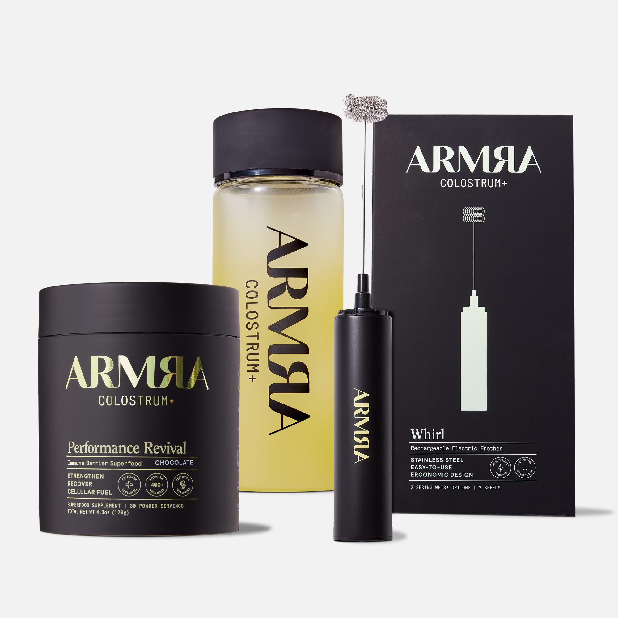 Black Jar of ARMRA Performance Revival and a Glass Water Bottle with Black Lid, Black Box and Black Electric Frother
