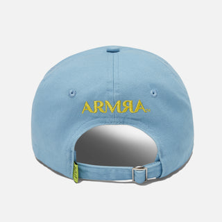 The back of a blue baseball cap with a yellow embroidered ARMRA Colostrum™ logo