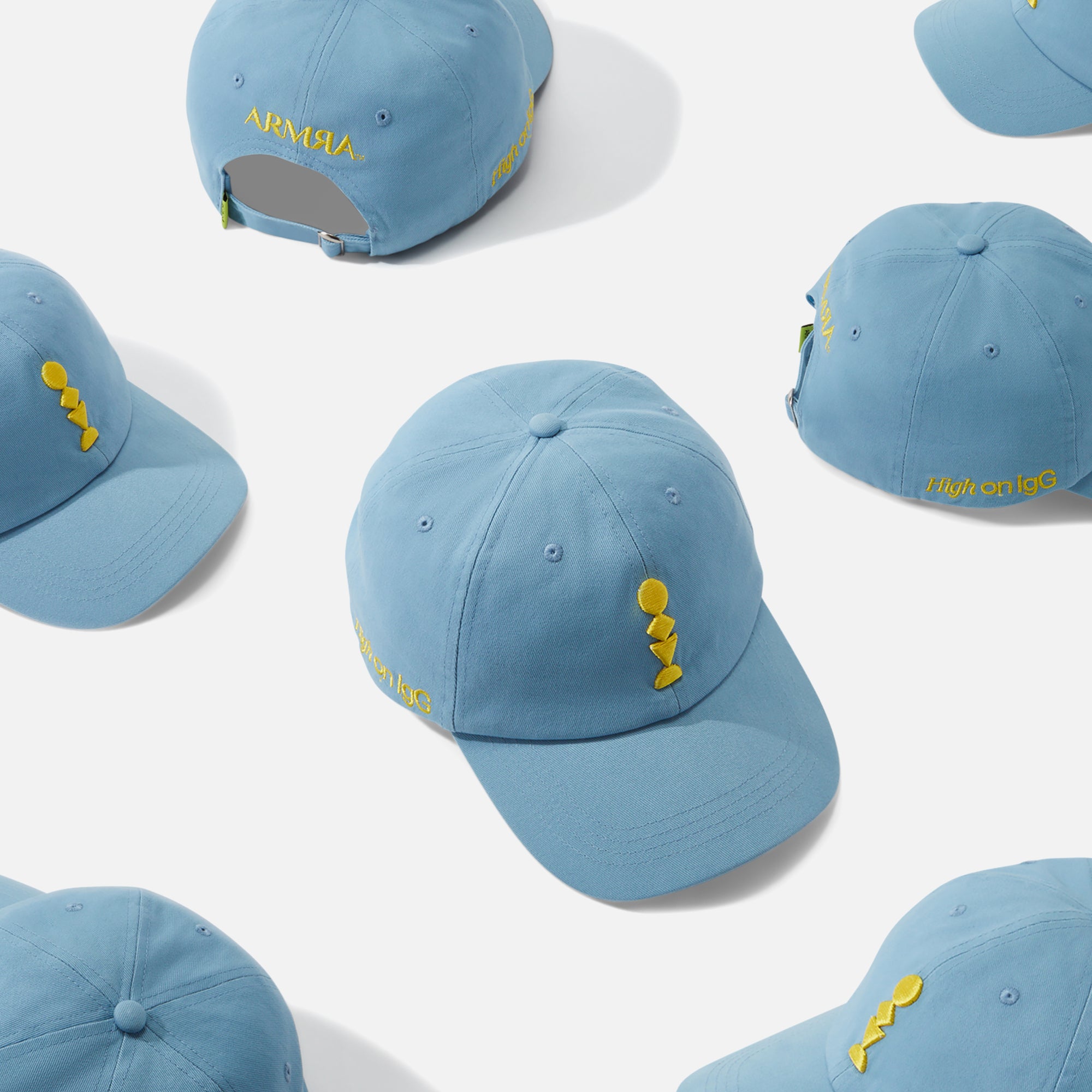 Blue Baseball Cap with a Yellow Embroidered Design on a White Background