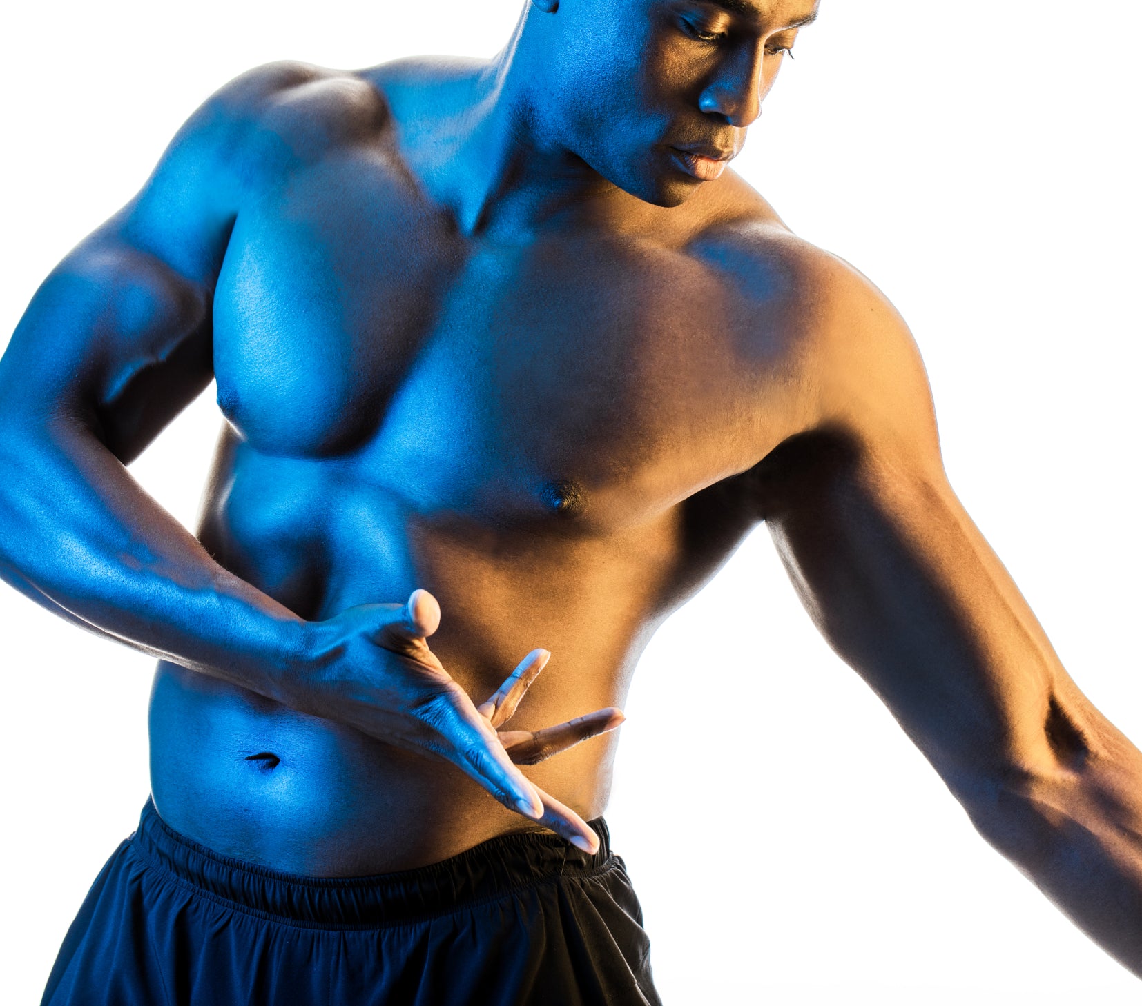 Man with no shirt and black shorts facing the camera with a blue glow to his skin, head tilted down and arms flexed