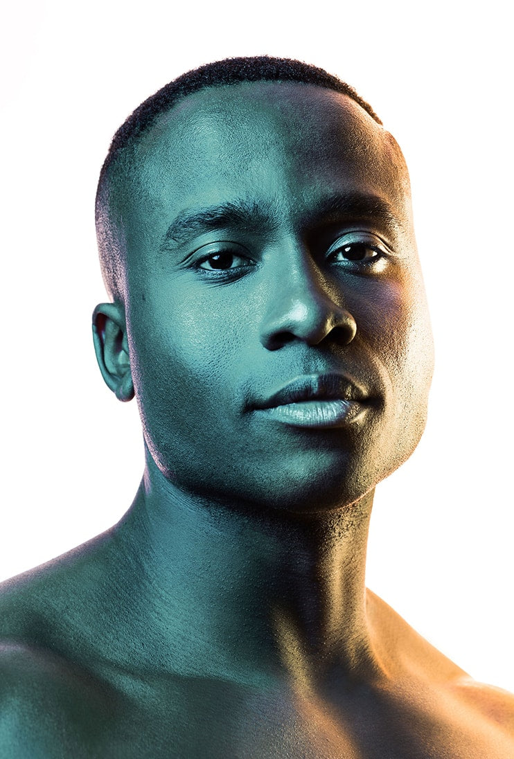 Photo of a healthy mans shoulders and head with a blue green light tint